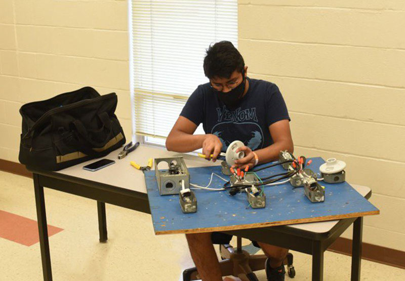student wearing a facemask in technical classroom