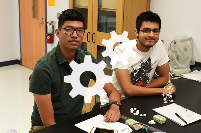 White gears logo over a photo of two students working on a science project in a lab classroom