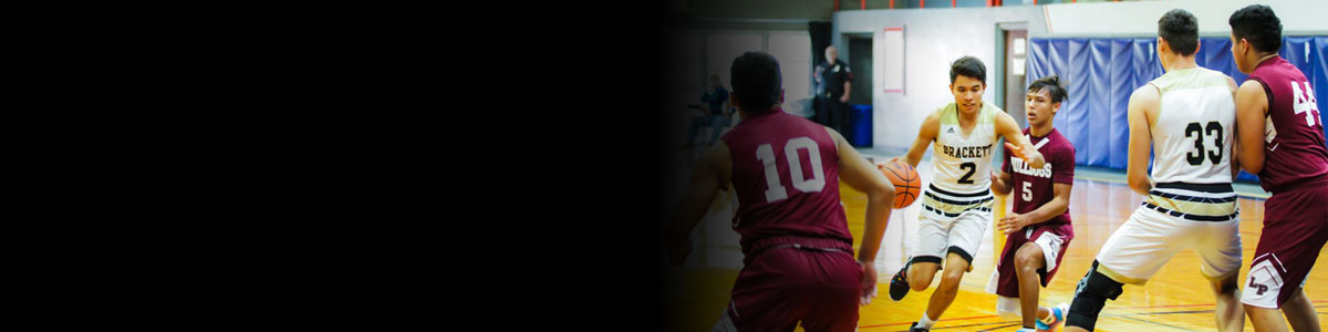 Image of two basketball teams playing in an indoor basketball court.